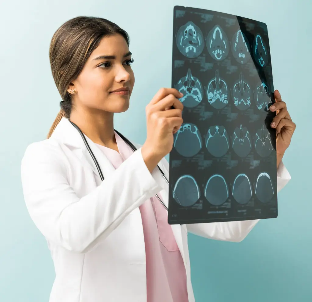 Radiology technologist reviewing brain MRI scans